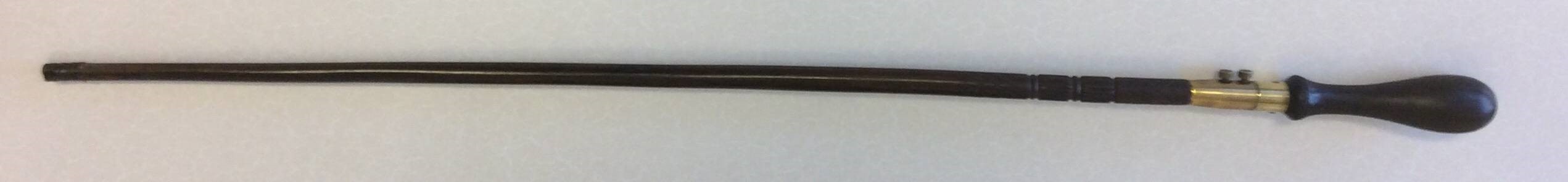 A simple rosewood stick with a brass section set just below the handle. Two small bolts hold the