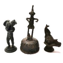 A small patinated bronze figure of a cherub with a dolphin, an Eastern bronze opium weight and a