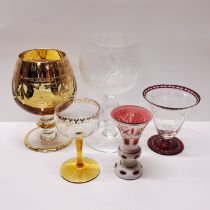 A fine hand engraved crystal wine goblet with four further glasses.