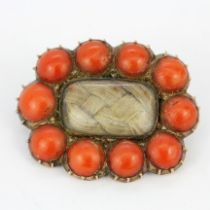 A Victorian gold backed coral set mourning brooch with hair compartment, L. 2.4cm.