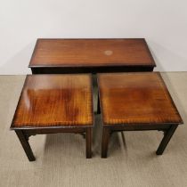 A cross banded and inlaid mahogany coffee table with two matching side tables, largest 107 x 46 x