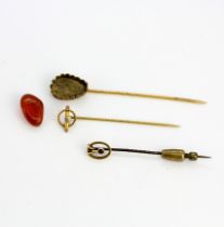 Two 9ct yellow gold tie pins together with a further yellow metal tie pin (with fallen stone).