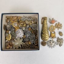 A quantity of military badges, buttons, etc.