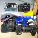 Two Canon cameras and photographic equipment.
