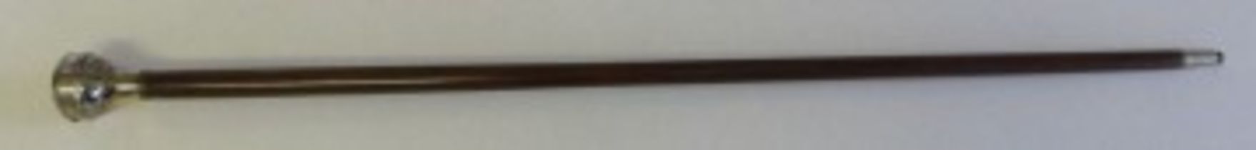The handle of this stick is of nickel plated brass; the cap of which hinges open to reveal a compass