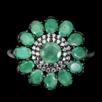 A 925 silver flower shaped ring set with oval cut emeralds and white stones, (N).