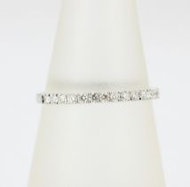 An 18ct yellow gold diamond set half eternity ring, (N).