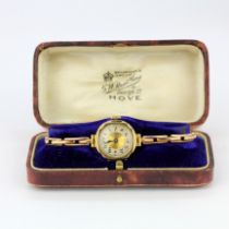 A vintage 9ct yellow gold lady's wrist watch on an expandable strap, with antique watch box.