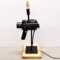 An interesting movie camera table lamp, H. 56cm.