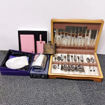 A boxed chromium plated cutlery set and other items.