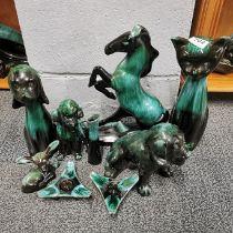 A group of Blue Mountain animal figures with a pair of candlesticks.