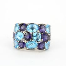 A 14ct white gold (stamped 14k) sapphire and blue topaz set ring, (O).