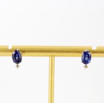 A pair of platinum stud earrings set with oval cut sapphires and diamonds, L. 1cm.