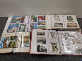 Four albums of mixed old postcards.