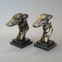 A pair of Art Deco style bronze greyhound head bookends on polished stone bases, H. 21cm.