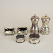 A pair of hallmarked silver salt and pepper grinders, together with a pair of hallmarked silver