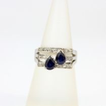 A white metal (tested 18ct gold) ring set with pear cut sapphires and diamonds, (M).