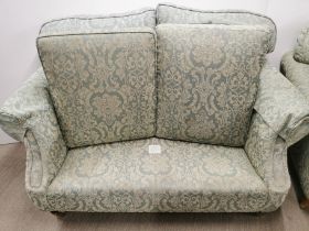 A two seater settee/ sofa on castors together with a matching armchair, settee H. 100cm D. 90cm W.