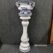 A hand-painted porcelain jardiniere on stand, H. 97cm.
