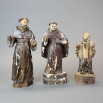Three 18th century Filipino carved wood and painted figures of saints, tallest H. 27cm.