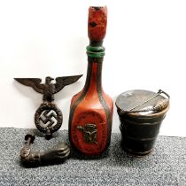Two cast iron items with a copper salt bucket and leather covered bottle.