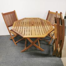 A folding garden table together with four matching folding garden chairs, table 102 x 73cm, and a