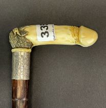 A novelty carved hippo tusk erotic walking stick cane, circa 1938, with a hallmarked silver
