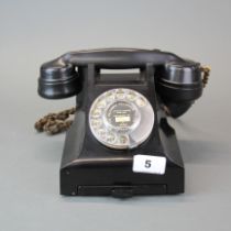 A Bakelite telephone with pull out telephone number drawer.