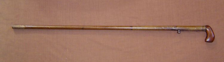 This is a mid 19th century underhammer percussion metal gun cane There is a brass shield mounted