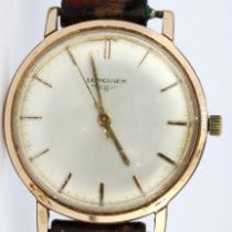 A 9ct yellow gold plated Longines wrist watch with a stainless steel back, on a leather strap. W.3.5