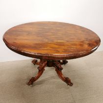 A rosewood veneered 19th C tilt top oak dining table, H. 80cm. W. 90cm L. 120cm. Missing screws.