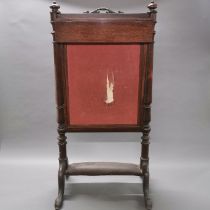 A 19th century mahogany fire screen with adjustable centre panel, H. 92cm.