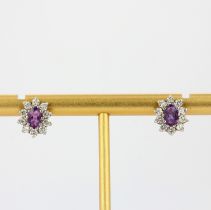 A pair of 9ct yellow gold amethyst and white stone set cluster earrings, L. 1.1cm.