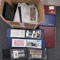 A box of mixed stamps in albums and loose.