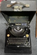 An Imperial portable typewriter with felt pad.