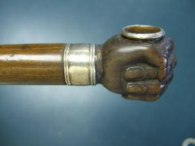Carved Soapstone Pipe A nice pipe stick. The handle of the cane is in the form of a hand/fist made