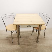 A handmade pine kitchen table with chrome legs and a single drawer together with two chrome and