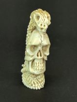 Hand carved stag antler skull with snake entertwined within the skeleton, H. 4.5cm.