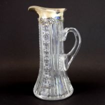 A superb cut crystal and sterling silver water jug, H. 25cm.