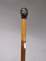 A 19th century sword stick with moulded phenolic negro head handle, L. 87cm.