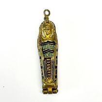 A rare Art Deco Egyptian gilt metal and enamelled revival sarcophagus and mummy Pendant, circa 1920,