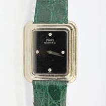 A lady's Piaget 18ct white gold wrist watch with a diamond set bezel, on a leather strap and white