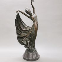 A large Art Deco style bronze figure of a dancer on a polished stone base, H. 57cm. Small chip to