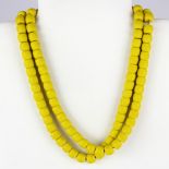 A string of Tibetan imperial yellow glass prayer beads, folded L. 48cm.