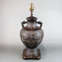 An impressive Chinese patinated bronze lamp base mounted on a further wooden base, H. 53cm.