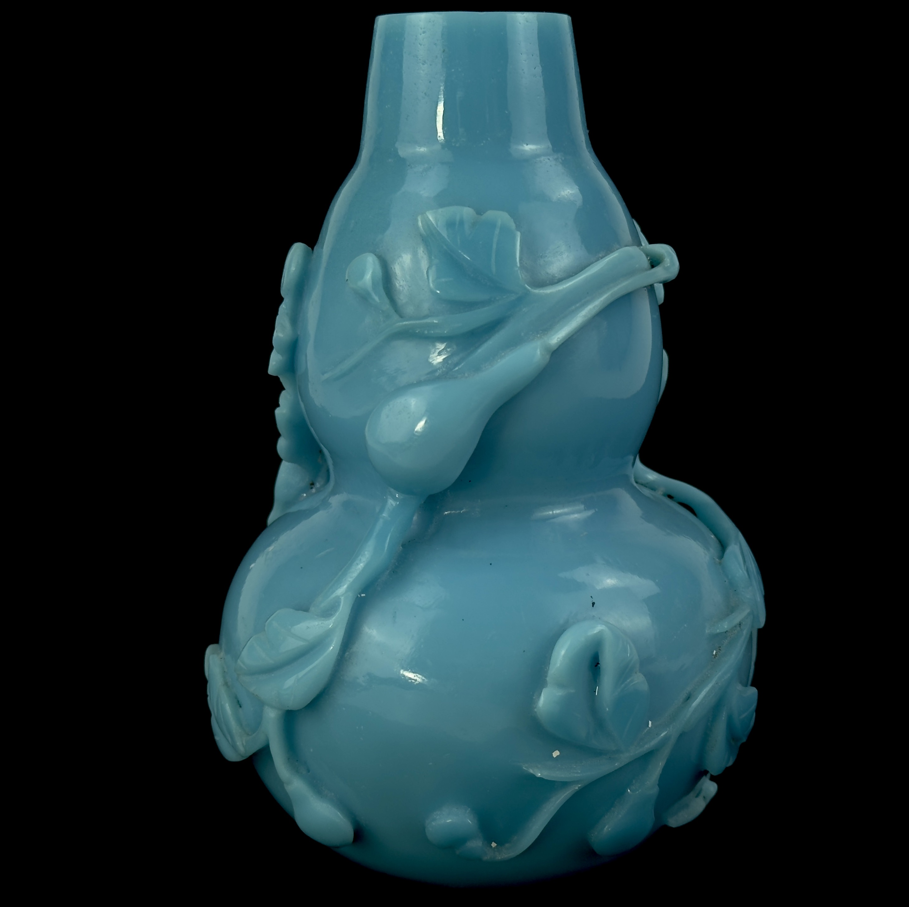 A blue Peking glass gourd vase with relief decoration, H. 17cm.