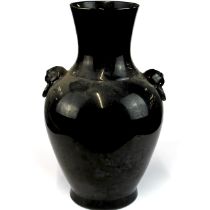 A Chinese black glazed porcelain vase, 19th/20th century, with lion head and ring handles, H. 34cm.
