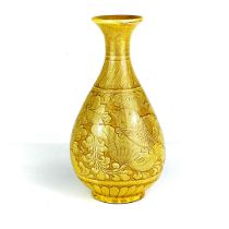 A Chinese yellow relief decorated crackle glazed pottery vase. H. 31cm.