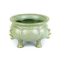 A Chinese celadon crackle glazed raised bowl on three feet, H. 10cm., W. 13cm.