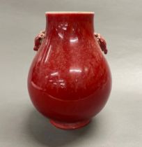 A large Chinese sang de boef glazed porcelain vase, with deer handles, H. 30cm.